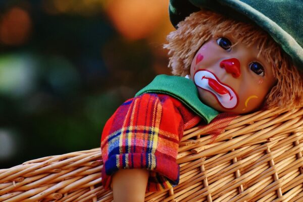 sad clown doll in basket